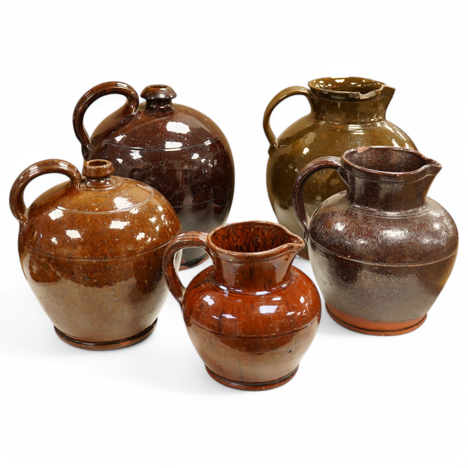 A group of stoneware glazed flagons and jugs, largest 29cm high. Condition - some chips